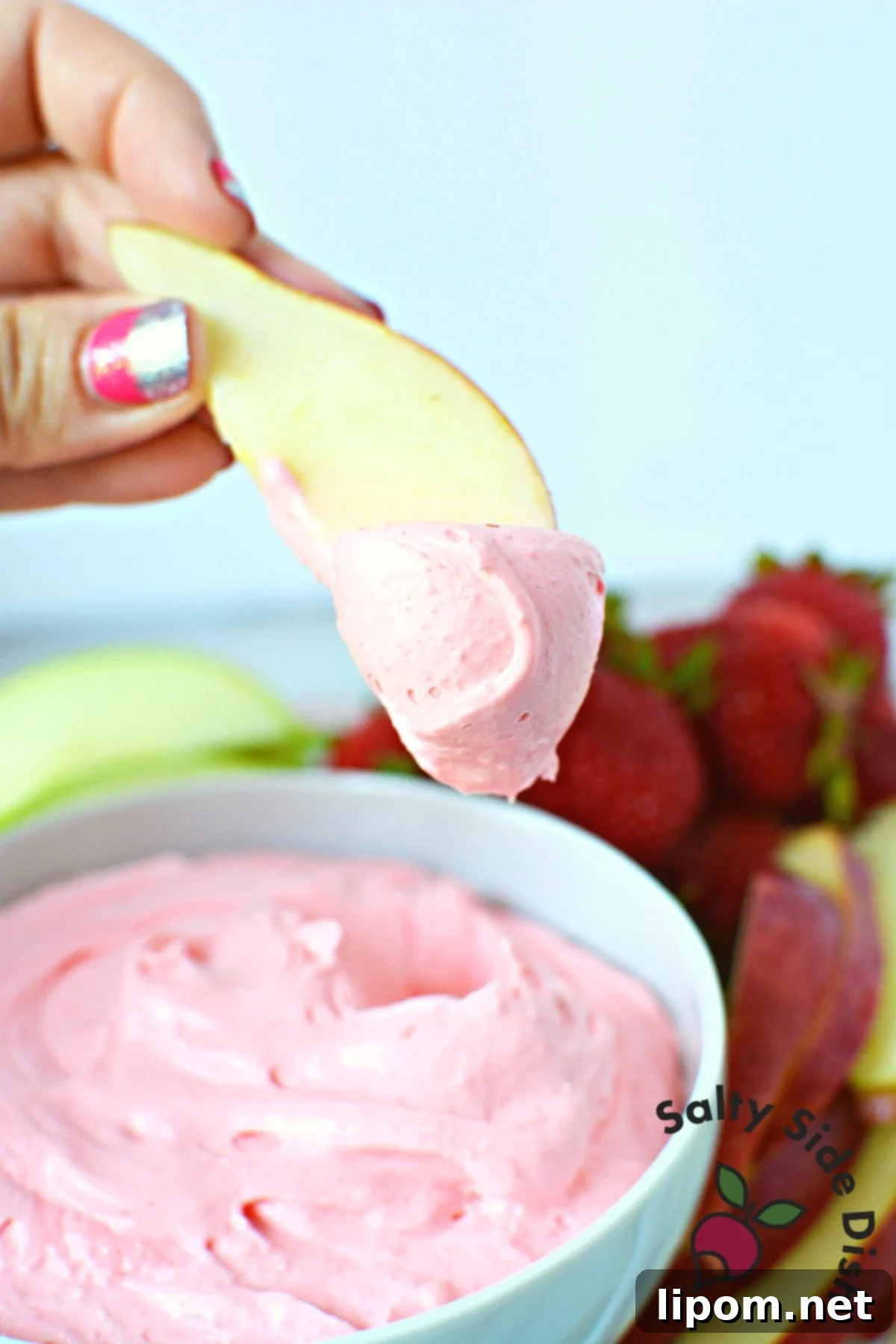 Luscious Strawberry Dip 4 Freshly sliced green apples beautifully arranged with a bowl of homemade strawberry fruit dip, ready to be enjoyed as a refreshing and easy dessert or snack.