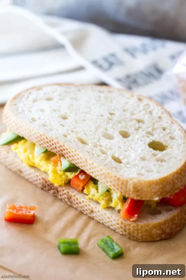 This hearty breakfast sandwich is made with San Luis Sourdough® Bread, scrambled eggs, bell peppers, pepper jack cheese, sausage, and avocado! It's an easy breakfast recipe that will stick with you all morning!