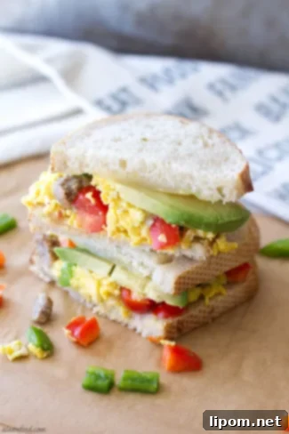 Sourdough Fiesta Breakfast Sandwich with eggs, sausage, cheese, peppers, and avocado.