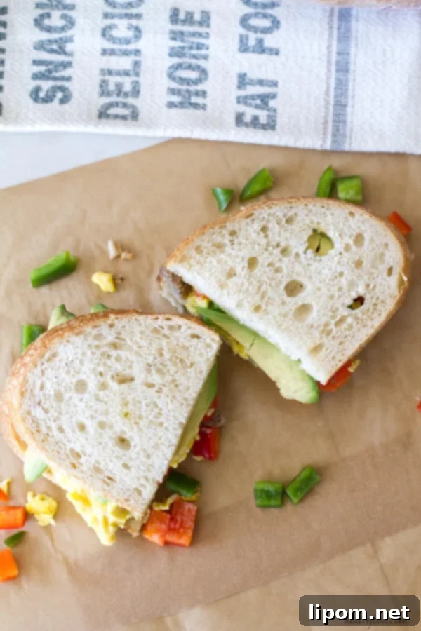This hearty breakfast sandwich is made with San Luis Sourdough® Bread, scrambled eggs, bell peppers, pepper jack cheese, sausage, and avocado! It's an easy breakfast recipe that will stick with you all morning!