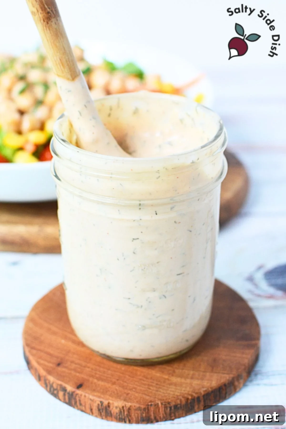 Smoky BBQ Ranch 2 A glass jar filled with creamy, orange-hued BBQ Ranch salad dressing, showcasing its rich texture and ready-to-serve appeal.