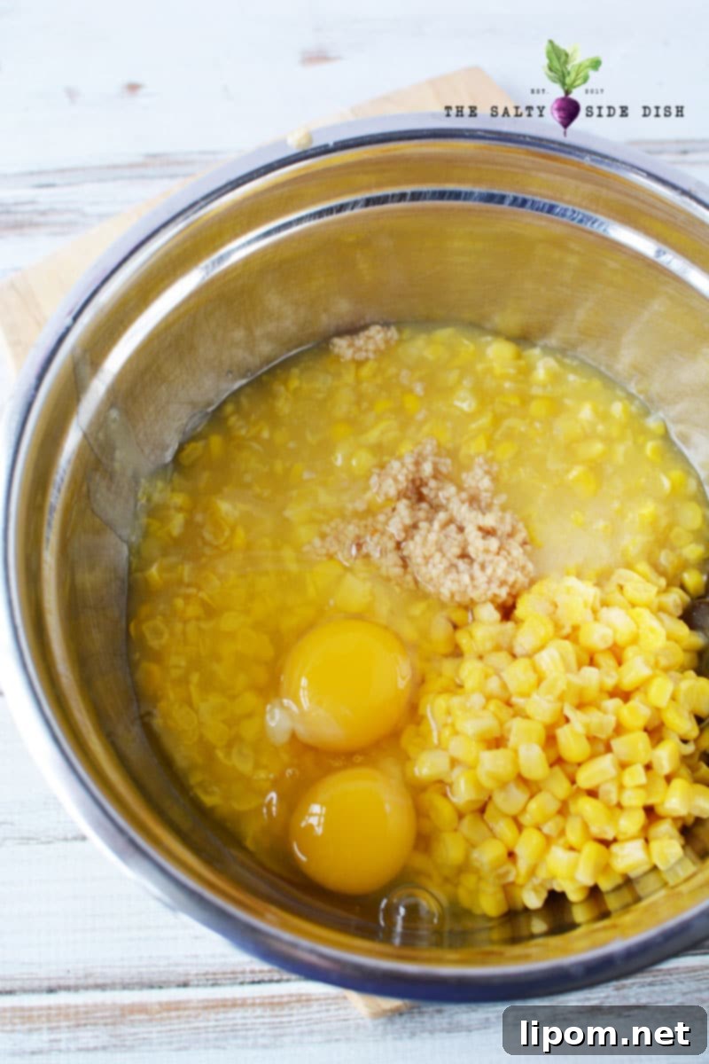Mixing the cornbread base ingredients with creamed corn and cornbread mix in a large bowl for the casserole.