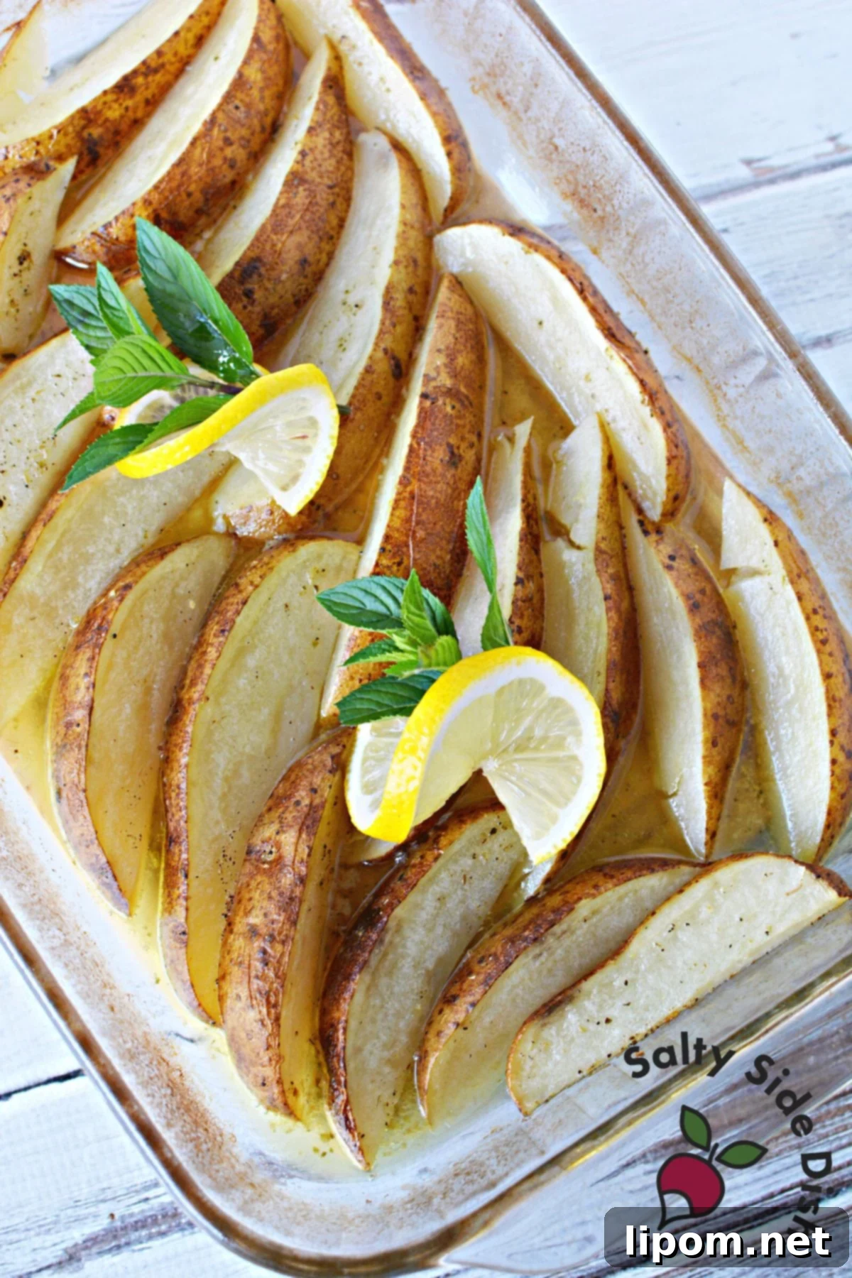 Zesty Greek Lemon Roasted Potatoes 2 Greek-style lemon potatoes roasted to perfection, showcasing their tender, non-crispy texture.