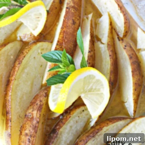 Zesty Greek Lemon Roasted Potatoes 11 fully cooked and tender potatoes in a baking dish.