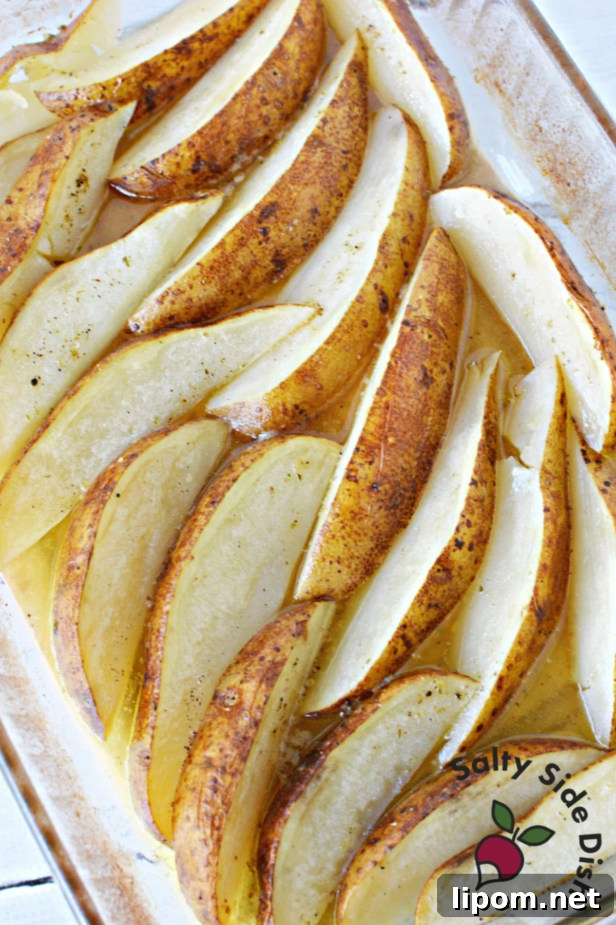 Zesty Greek Lemon Roasted Potatoes 9 A vibrant and tender potato side dish in a baking pan, ready to be served to a crowd.
