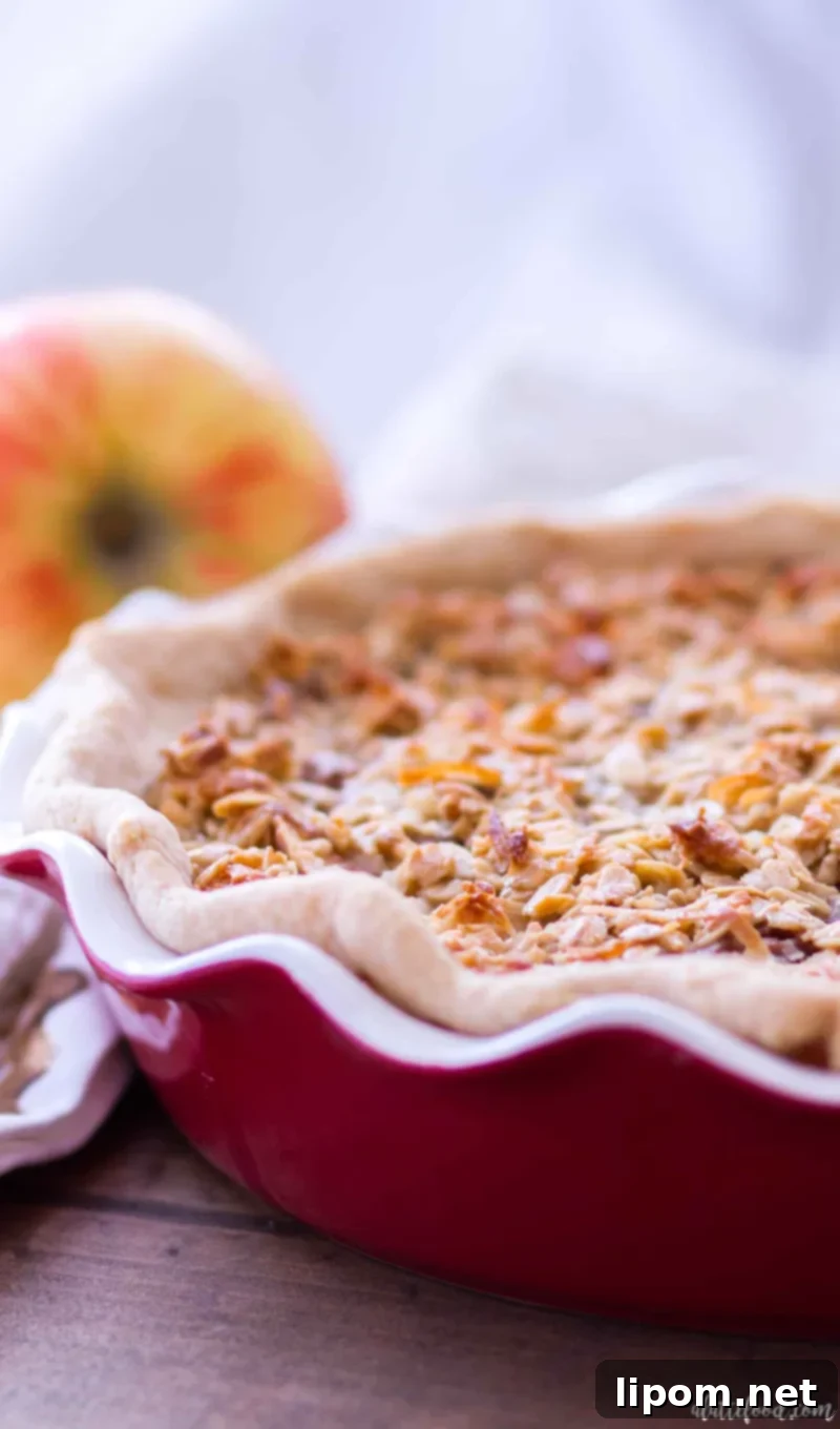 Top-down view of a golden-brown Maple Oatmeal Apple Pie, fresh from the oven