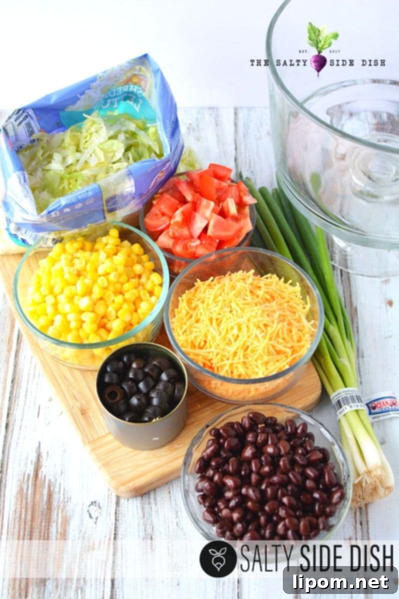 Fiesta Taco Stack 3 Assorted taco salad ingredients laid out beautifully on a counter.
