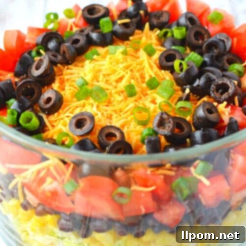 Fiesta Taco Stack 7 A vibrant and fresh Layered Taco Salad with homemade Ranch Taco Dressing, beautifully presented.