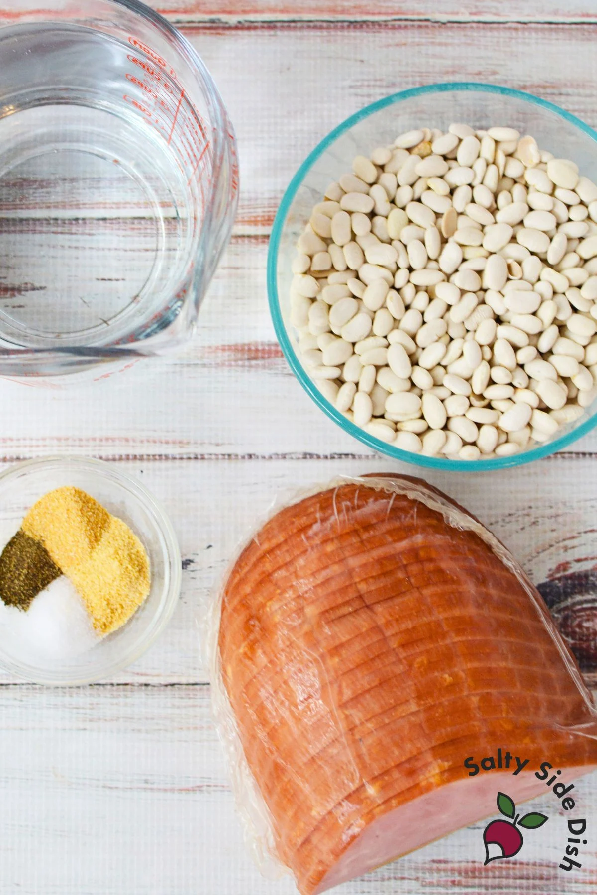 Ingredients for slow cooker ham and beans including dried great northern beans, diced ham, water, and spices