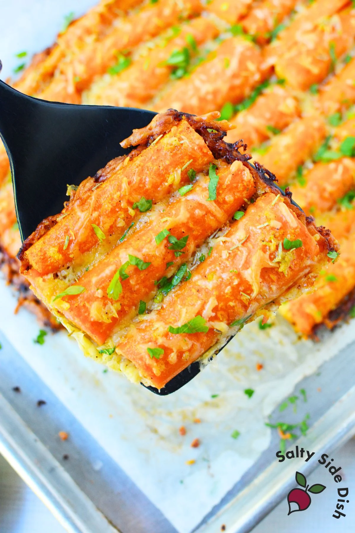 Easy sheet pan garlic parmesan carrots baked with crispy cheese and herbs — a flavorful carrot side dish for Thanksgiving dinner.