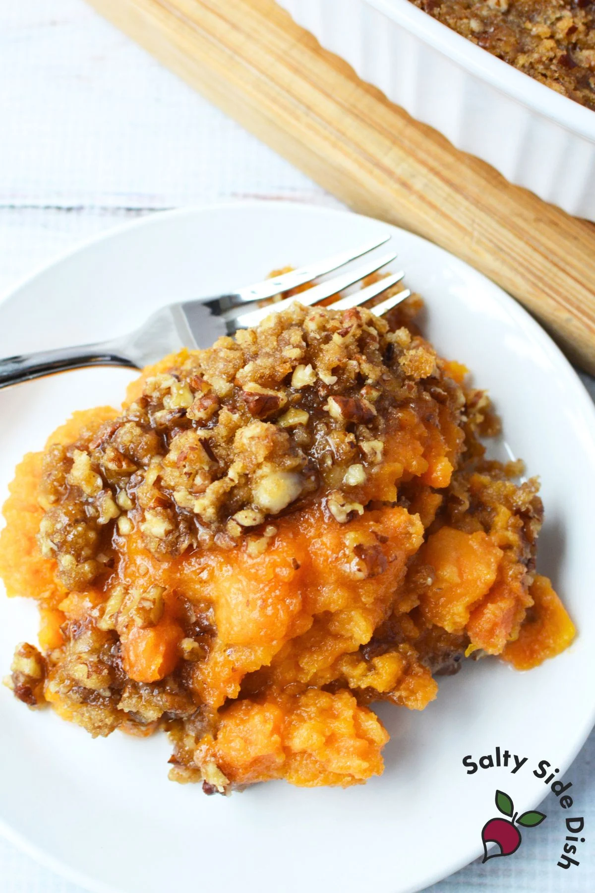 Plated serving of sweet potato casserole with rich pecan crunch topping, copycat Ruth’s Chris recipe.