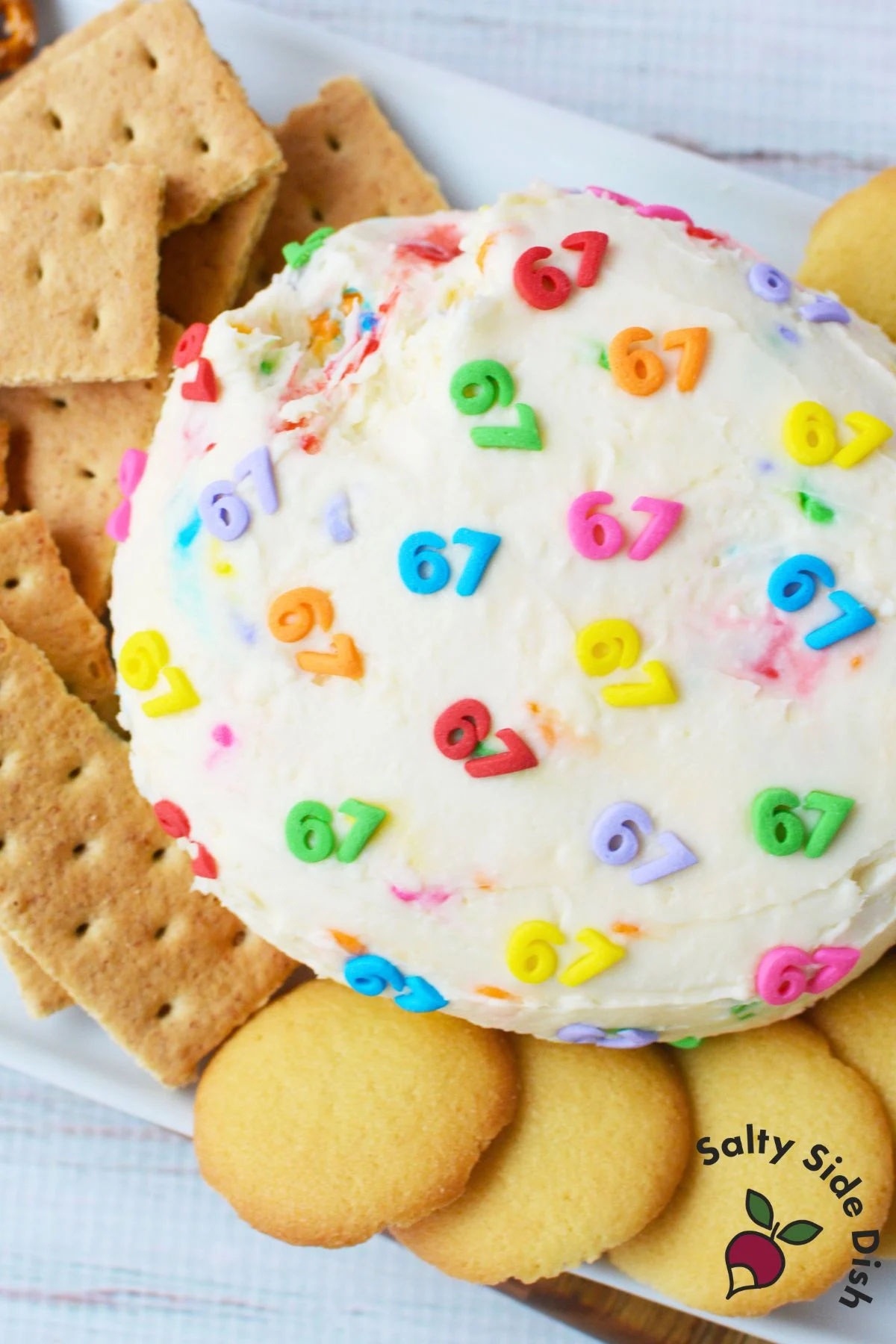 6-7 cheeseball dessert served on a platter with pretzels, graham crackers, and Nilla wafers for easy holiday snacking.