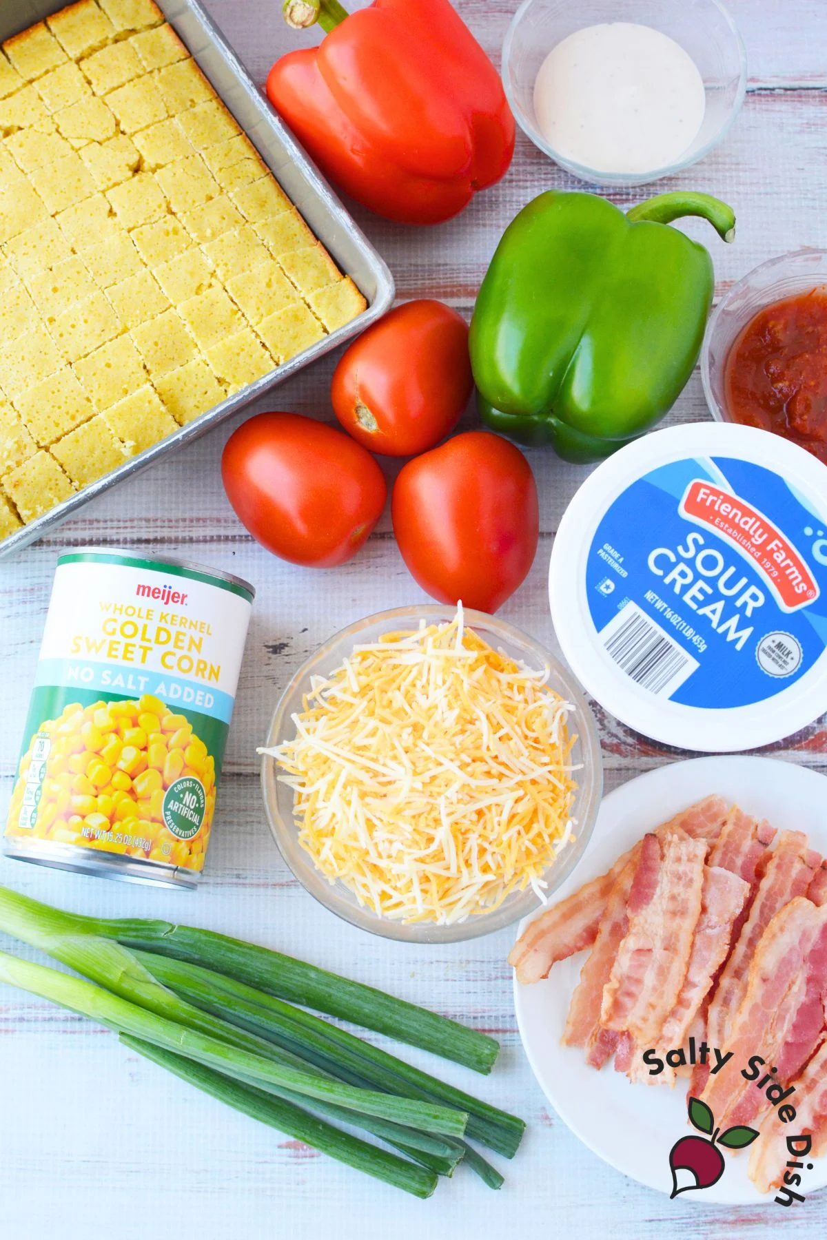 cornbread salad ingredients including cornbread corn tomatoes bell peppers cheese and bacon