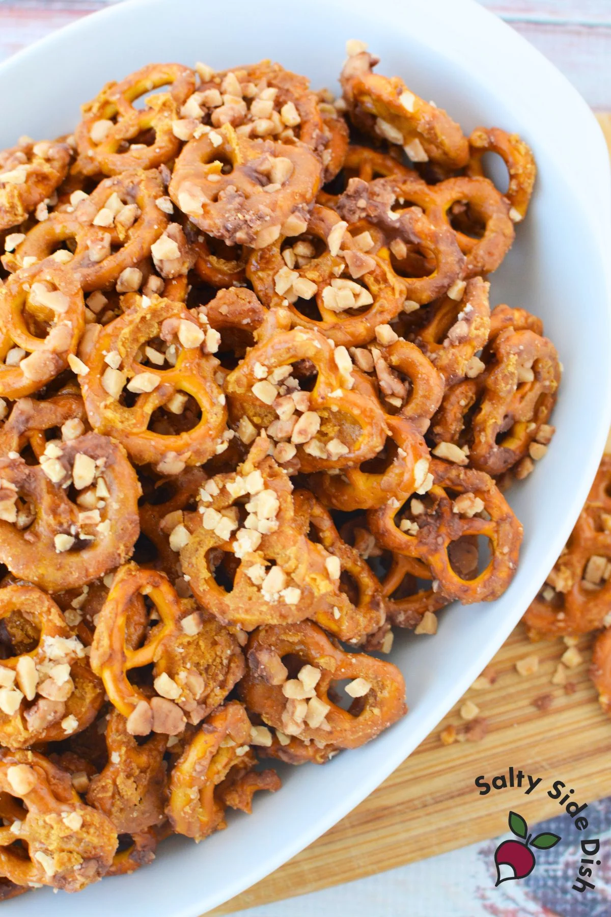 bowl of butter toffee pretzels topped with toffee bits, simple holiday snack idea