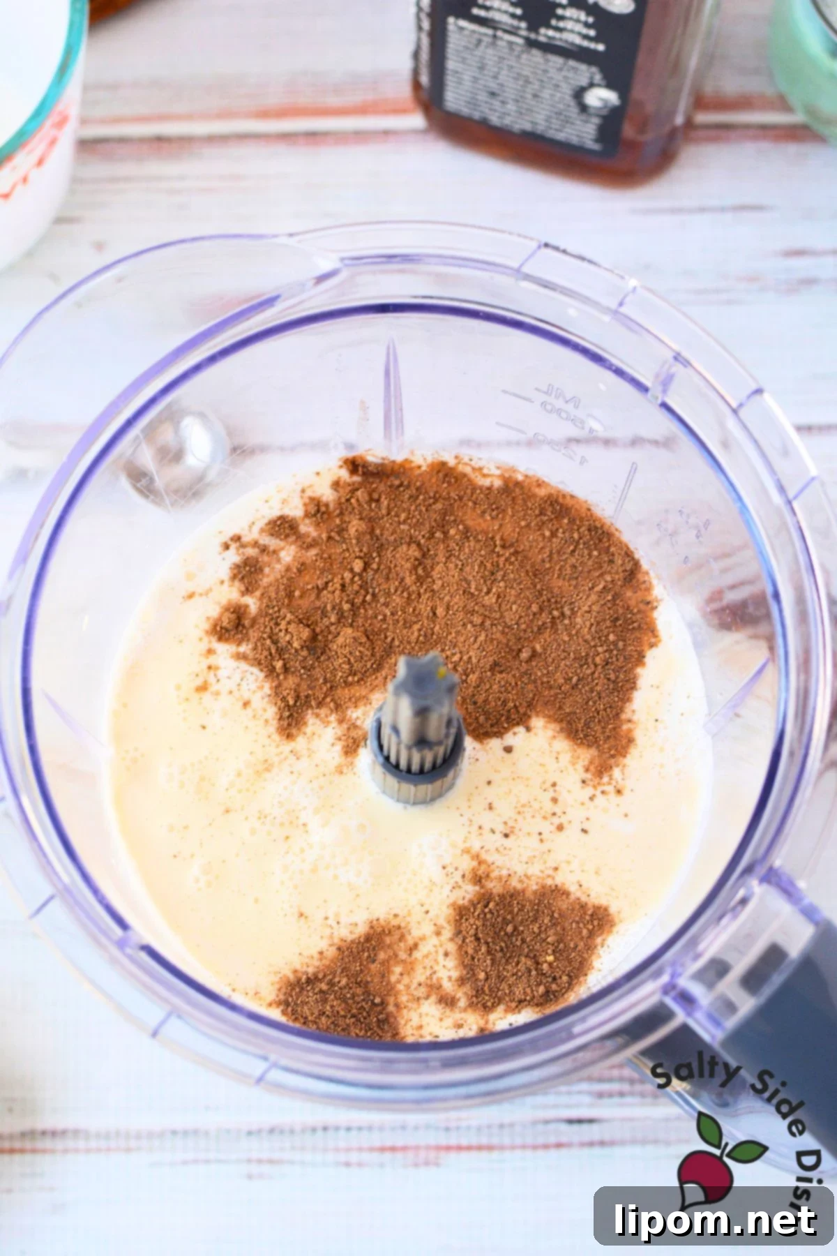 Spiked Holiday Cheer 4 A blender swirling with a mixture of pasteurized eggs, creamy milk, rich cream, golden honey, smooth bourbon, aromatic rum, and freshly ground nutmeg, ready to become a delicious spiked eggnog.