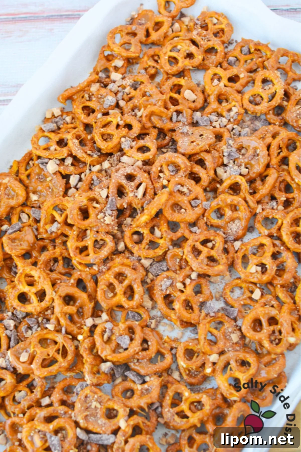 Sweet and Salty Pretzel Bites 6 Sweet and salty butter toffee pretzels cooling on a parchment lined baking sheet