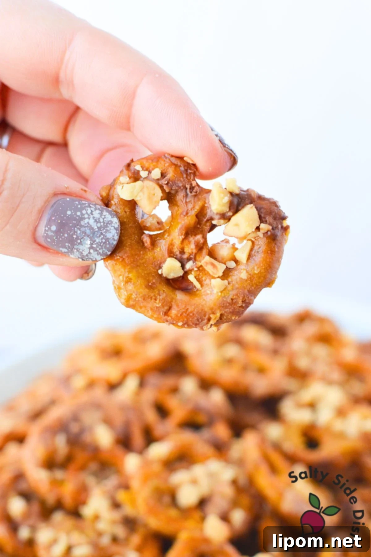 Sweet and Salty Pretzel Bites 7 Hand holding heath pretzels.