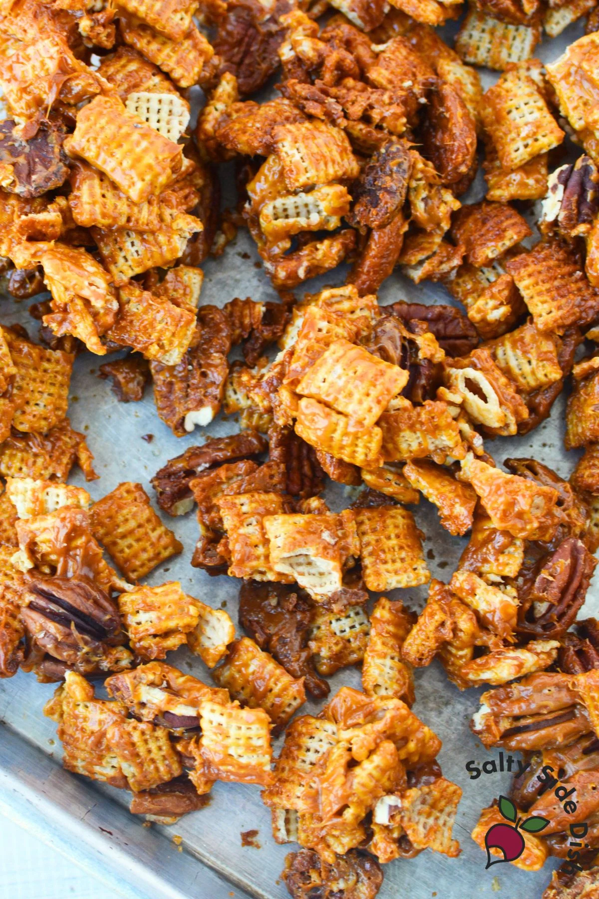 Baked caramel pecan clusters cooling on a baking sheet after oven baking
