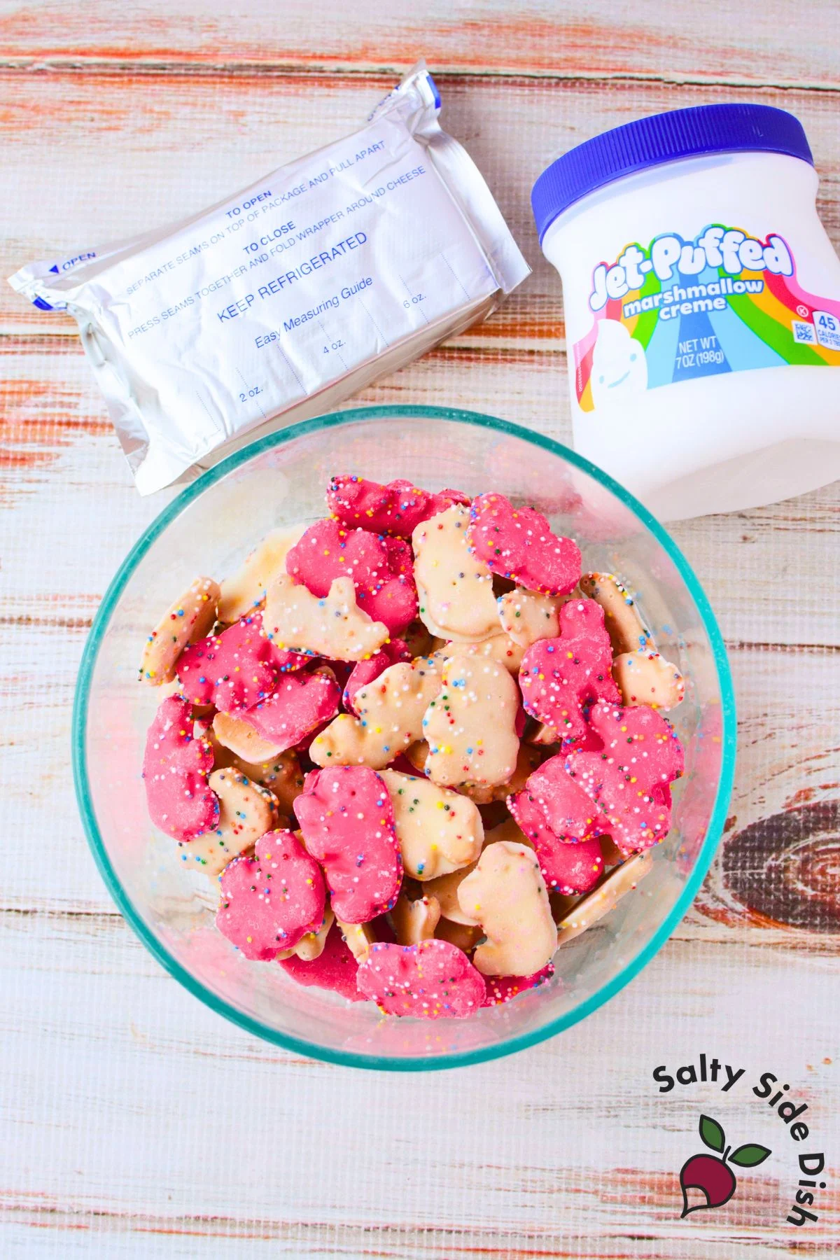 Ingredients for frosted animal cracker dip including cream cheese marshmallow cream and circus animal cookies