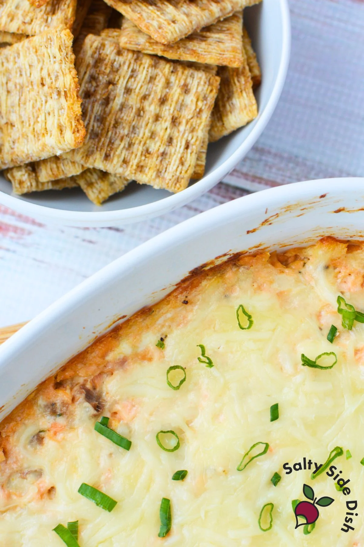 Cheesy baked salmon dip served warm with crackers for dipping