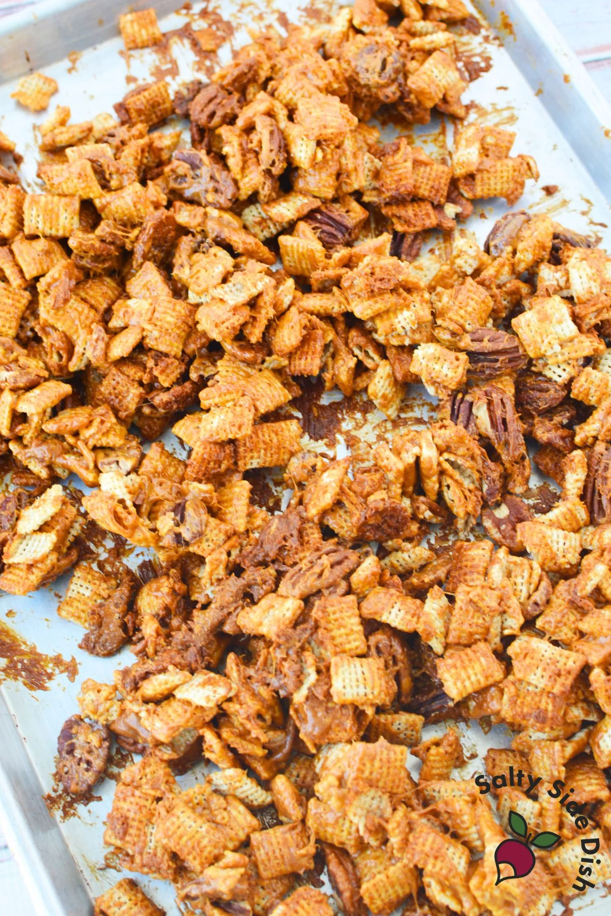 Caramel pecan clusters flipped onto a second baking sheet to cool and set