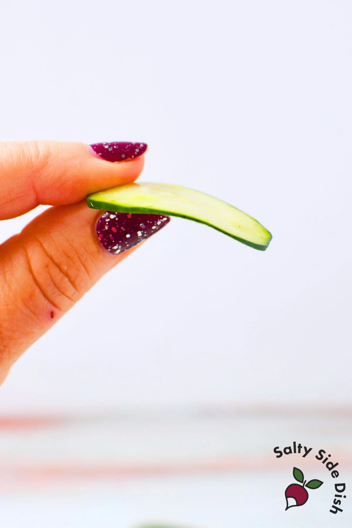 Very thin cucumber slice bending easily to show correct thickness for cucumber roses