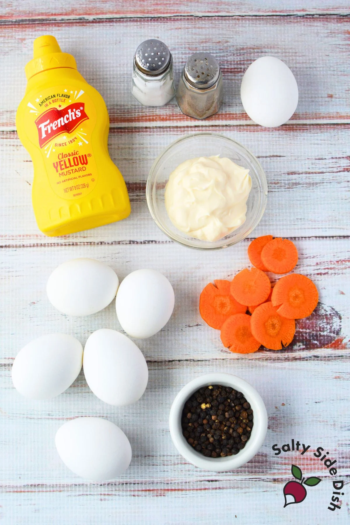 ingredients for chick deviled eggs including eggs, mayonnaise, mustard, carrots, and peppercorns