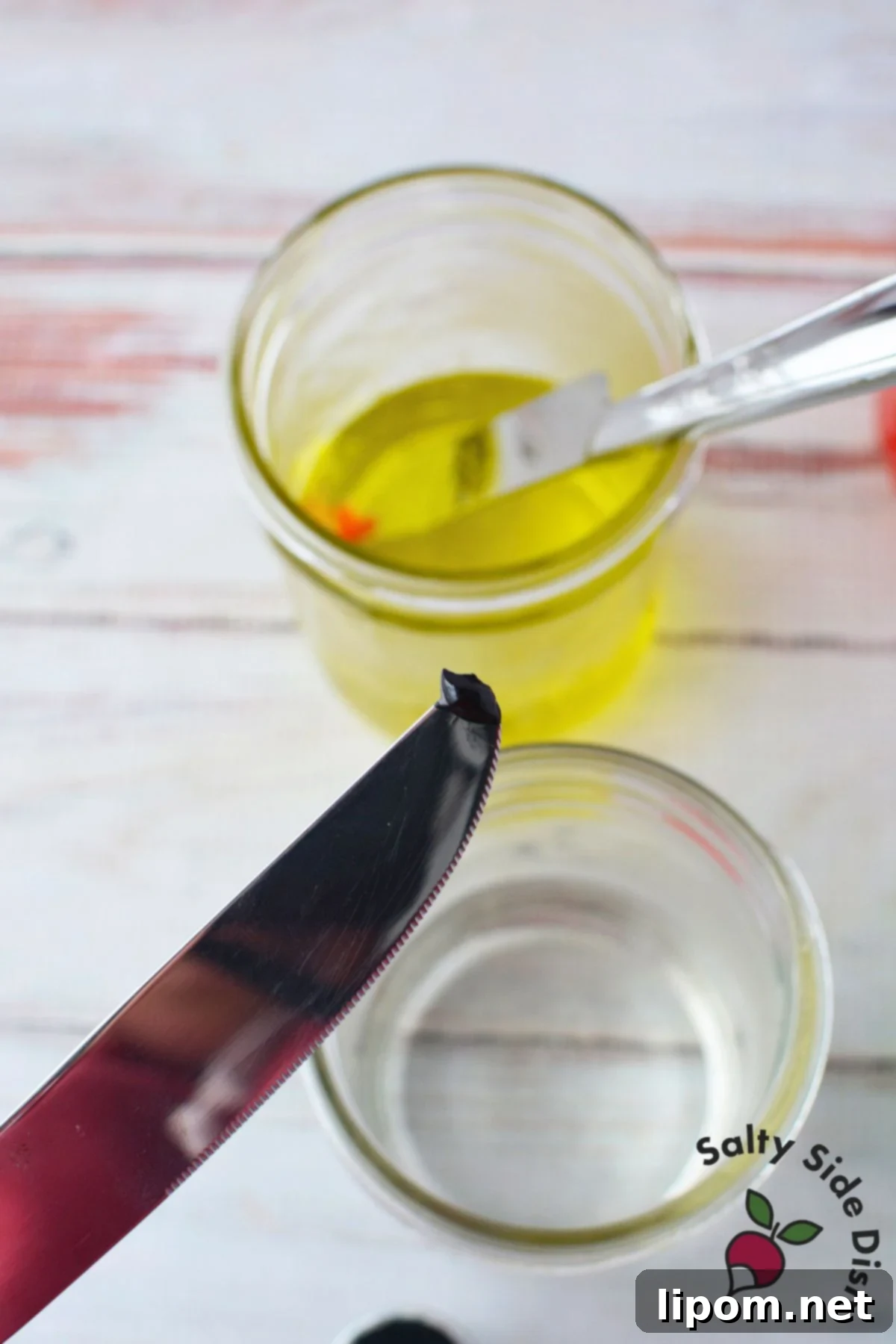 Water, vinegar, and food coloring mixtures in bowls for dyeing deviled egg whites.