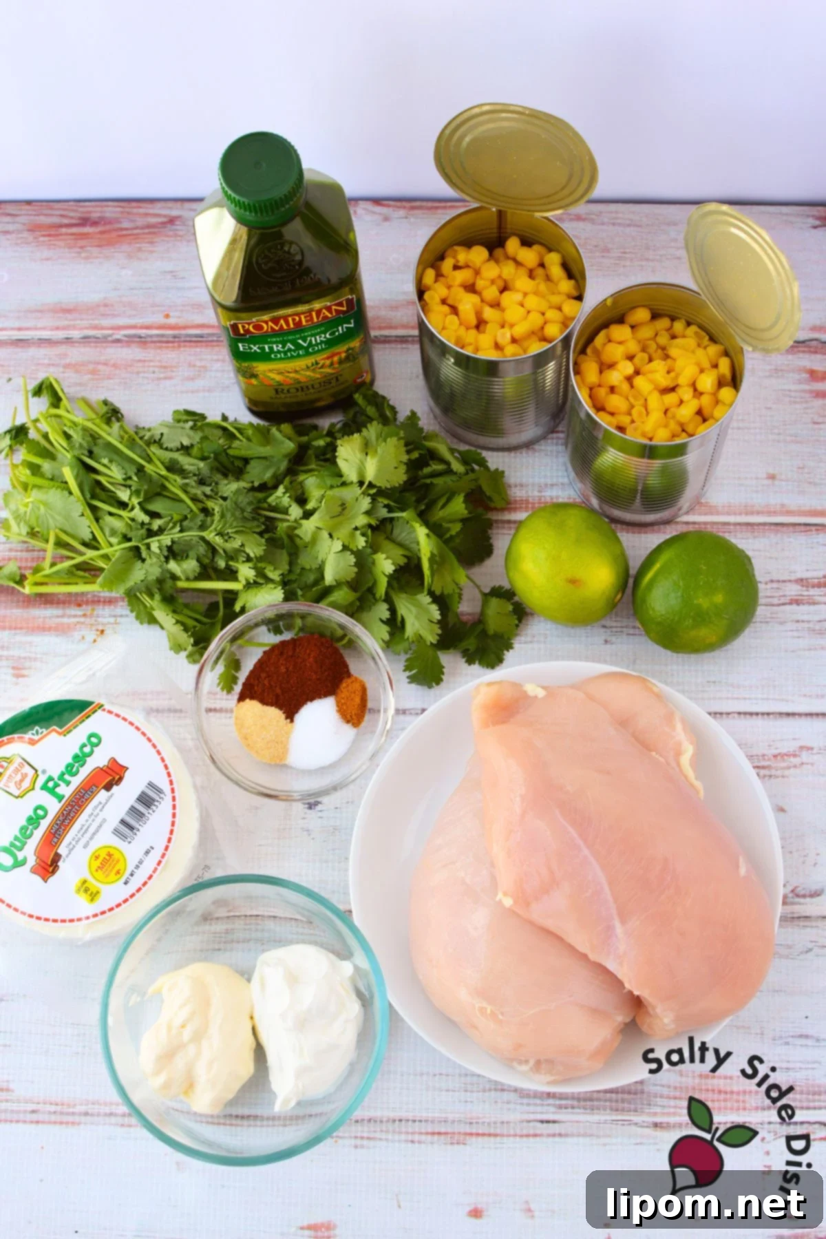 Mexican Street Corn Chicken Casserole 3 Ingredients for Mexican street corn chicken bake including canned corn, chicken breasts, queso fresco, olive oil, limes, cilantro, sour cream, mayonnaise, and spices