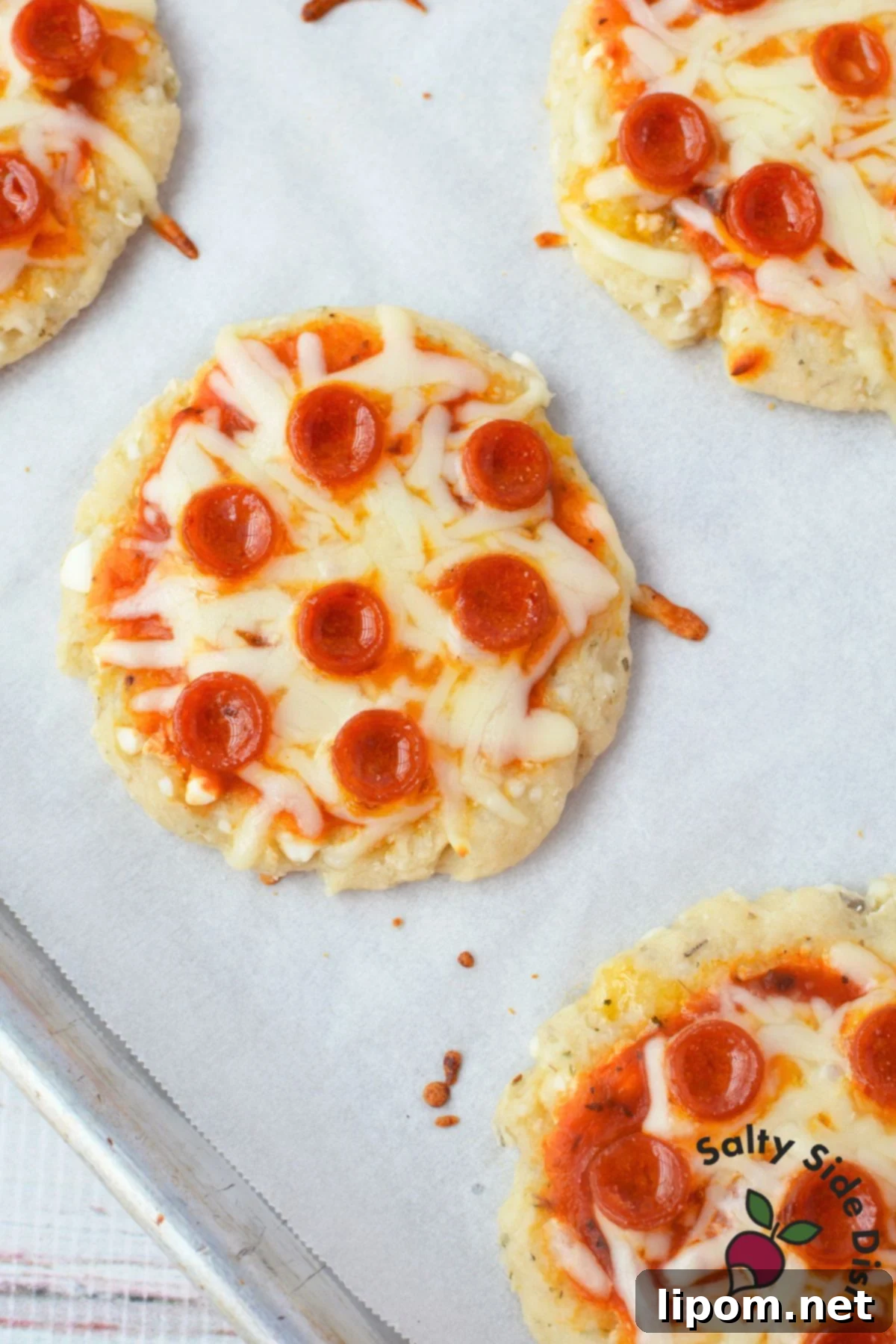 Baked cottage cheese mini pizza with melted mozzarella and pepperoni
