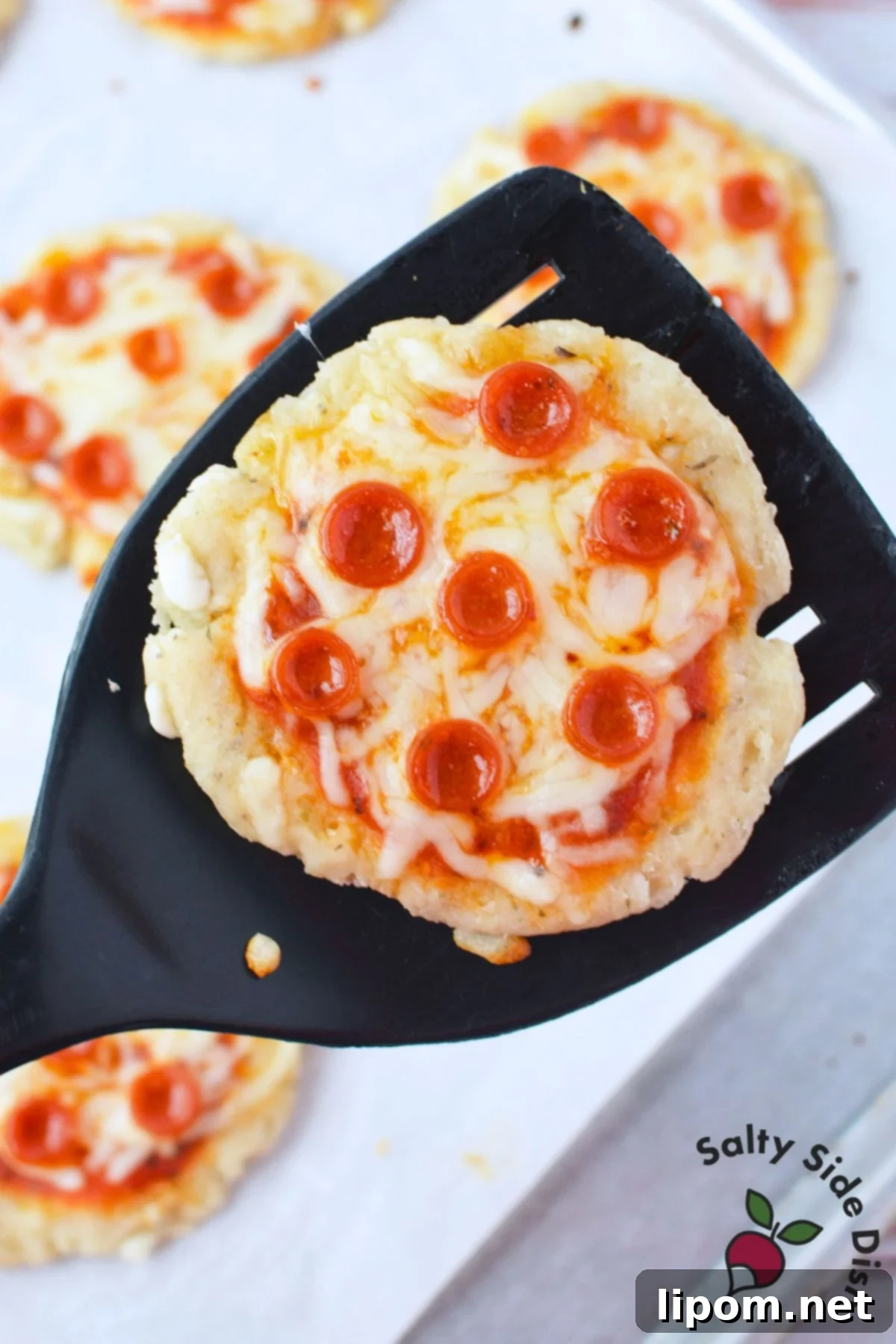 Cottage Cheese Pizza Bites 8 Baked cottage cheese mini pepperoni pizza on a spatula