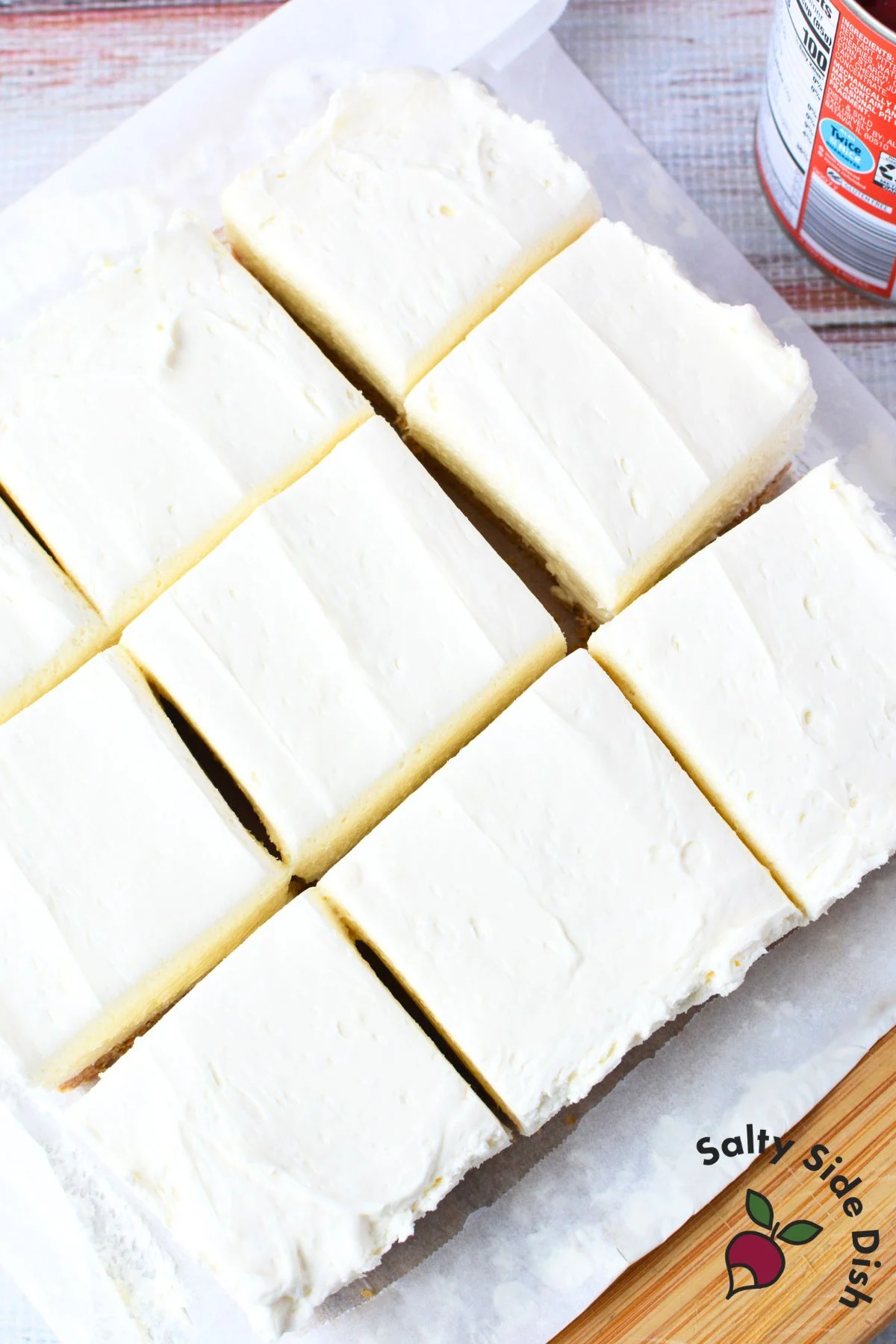 no bake cherry cheesecake bars cut into squares on parchment paper