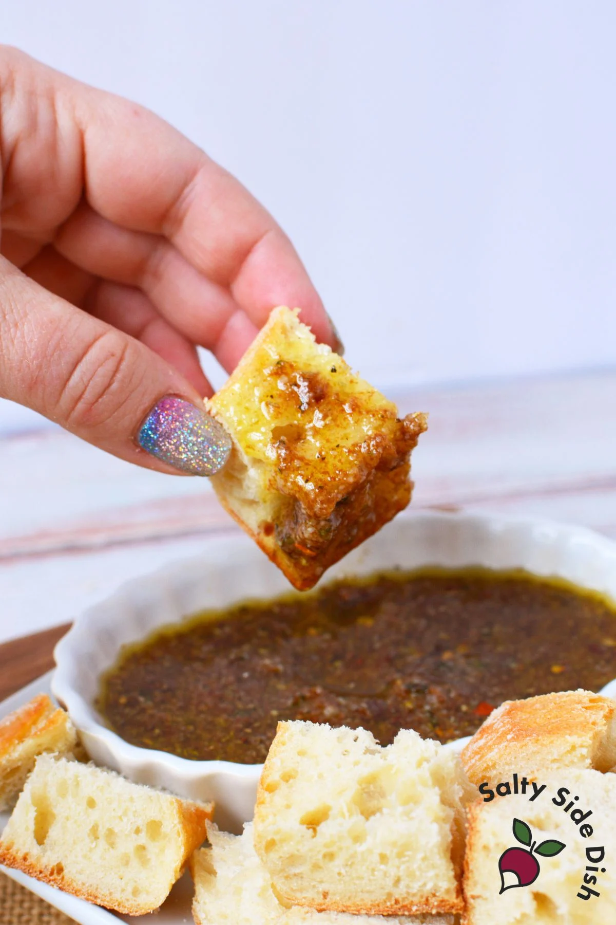 Homemade olive oil bread dip recipe served with toasted bread cubes and Italian seasonings
