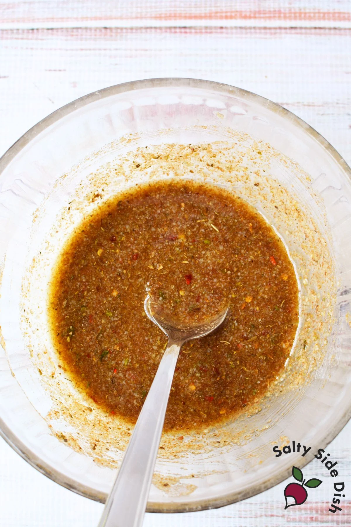 Close up of olive oil balsamic vinegar bread dip with herbs, parmesan, and crusty bread