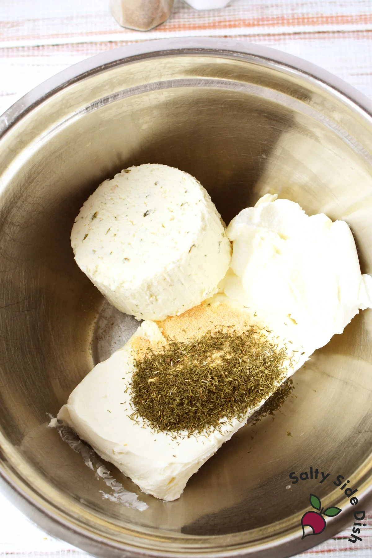 cream cheese, Boursin, ricotta, dill, and garlic powder in a mixing bowl before combining