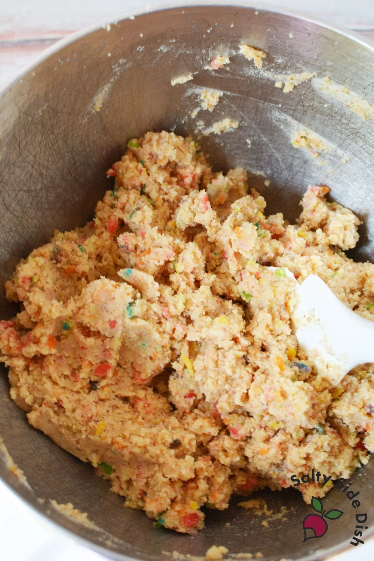 Fruity pebbles cake batter mixed in a stainless steel bowl