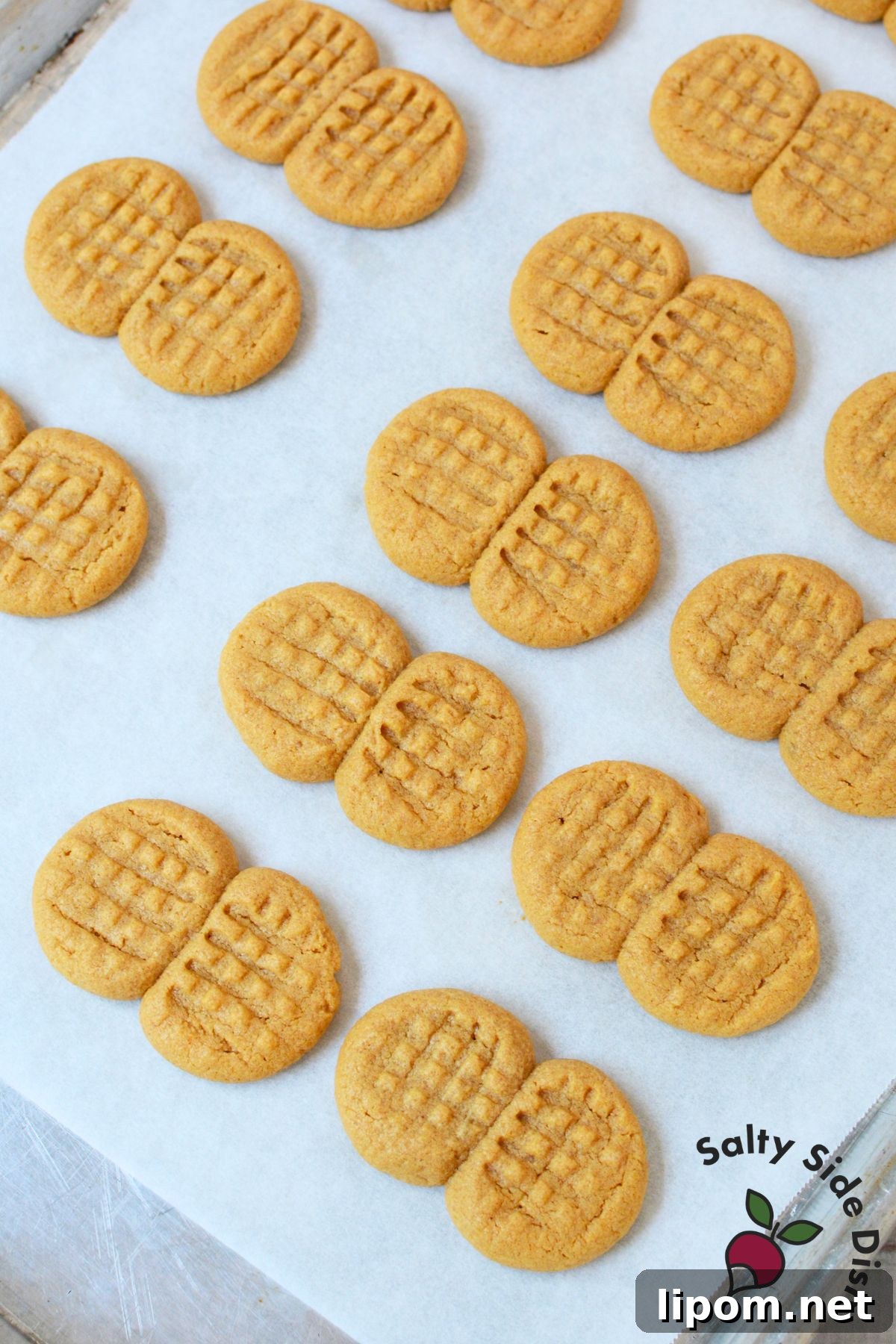 Copycat Nutter Butter Peanut Butter Cookies 5 Nutter butter cookie dough pressed into a crosshatch pattern on a parchment lined baking sheet
