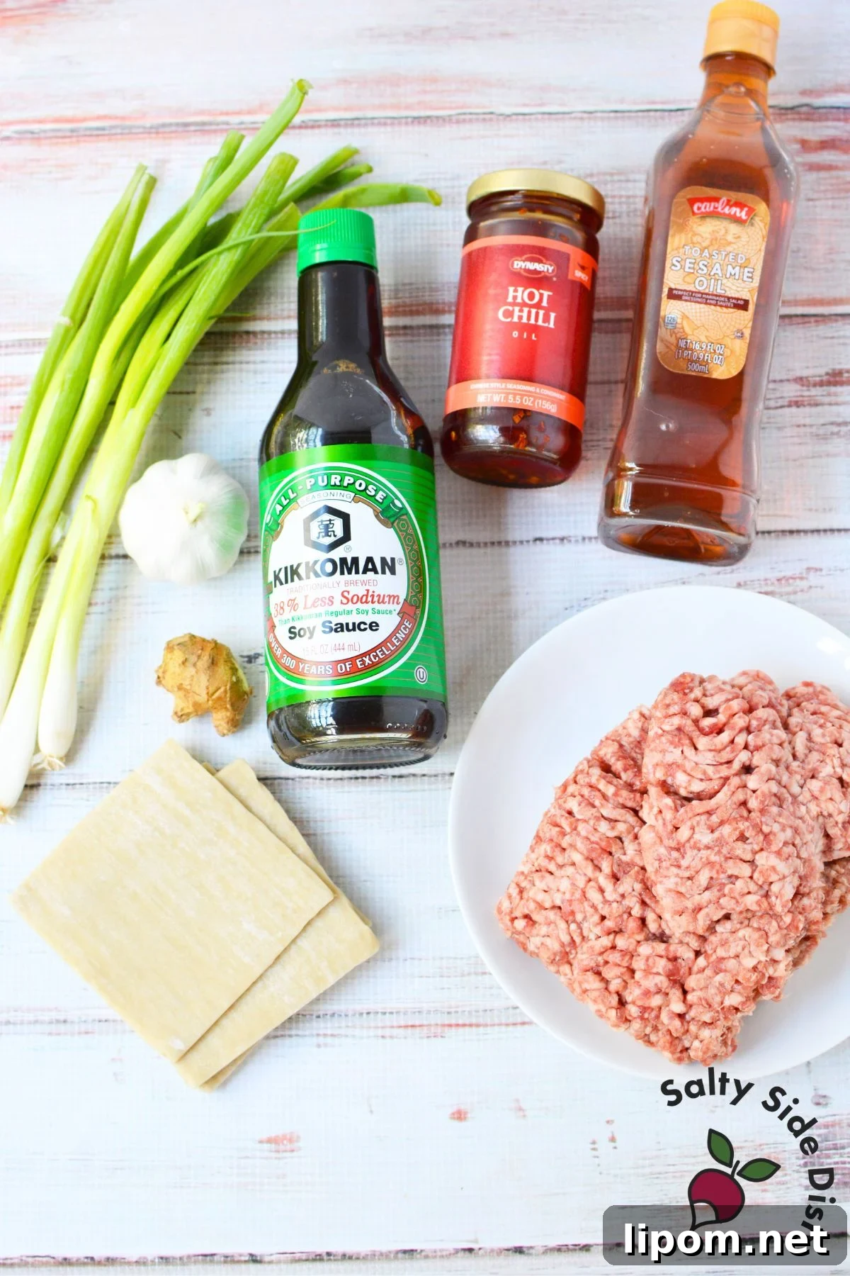 Cheesy Dumpling Lasagna Casserole with Pork and Scallions 3 Ingredients for dumpling lasagna, including ground pork, wonton wrappers, green onions, garlic, ginger, soy sauce, chili oil, and sesame oil.