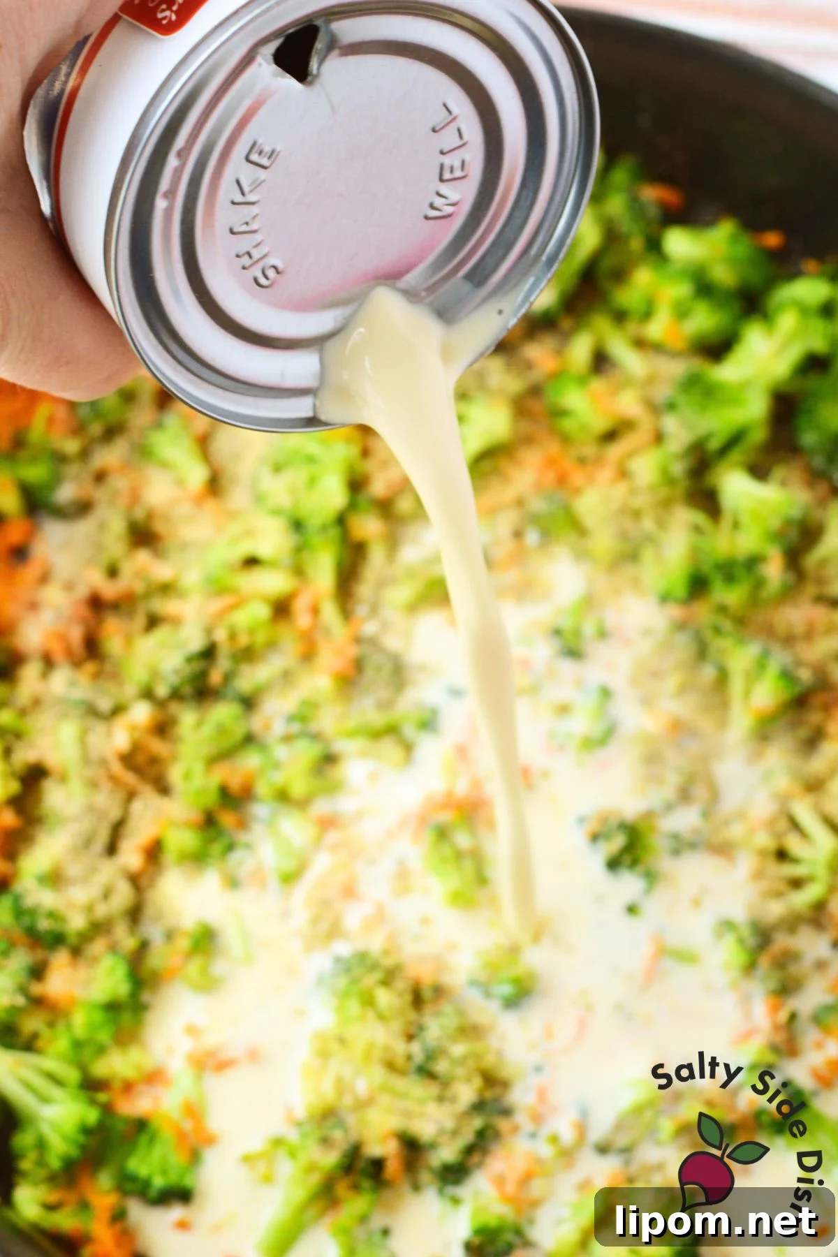Creamy Chicken, Bacon and Broccoli Pasta with Cheese 4 Evaporated milk being poured into a skillet of broccoli, carrots, and seasonings for creamy pasta sauce.