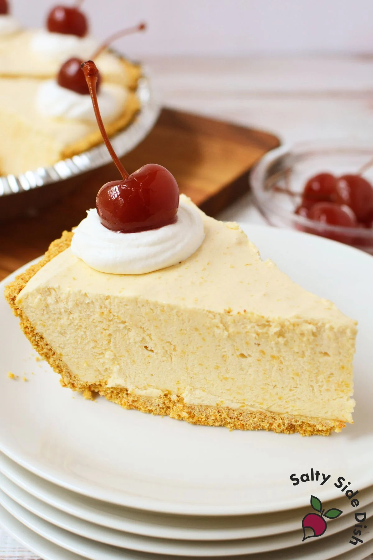 Slice of root beer float pie on a plate with whipped cream and cherry