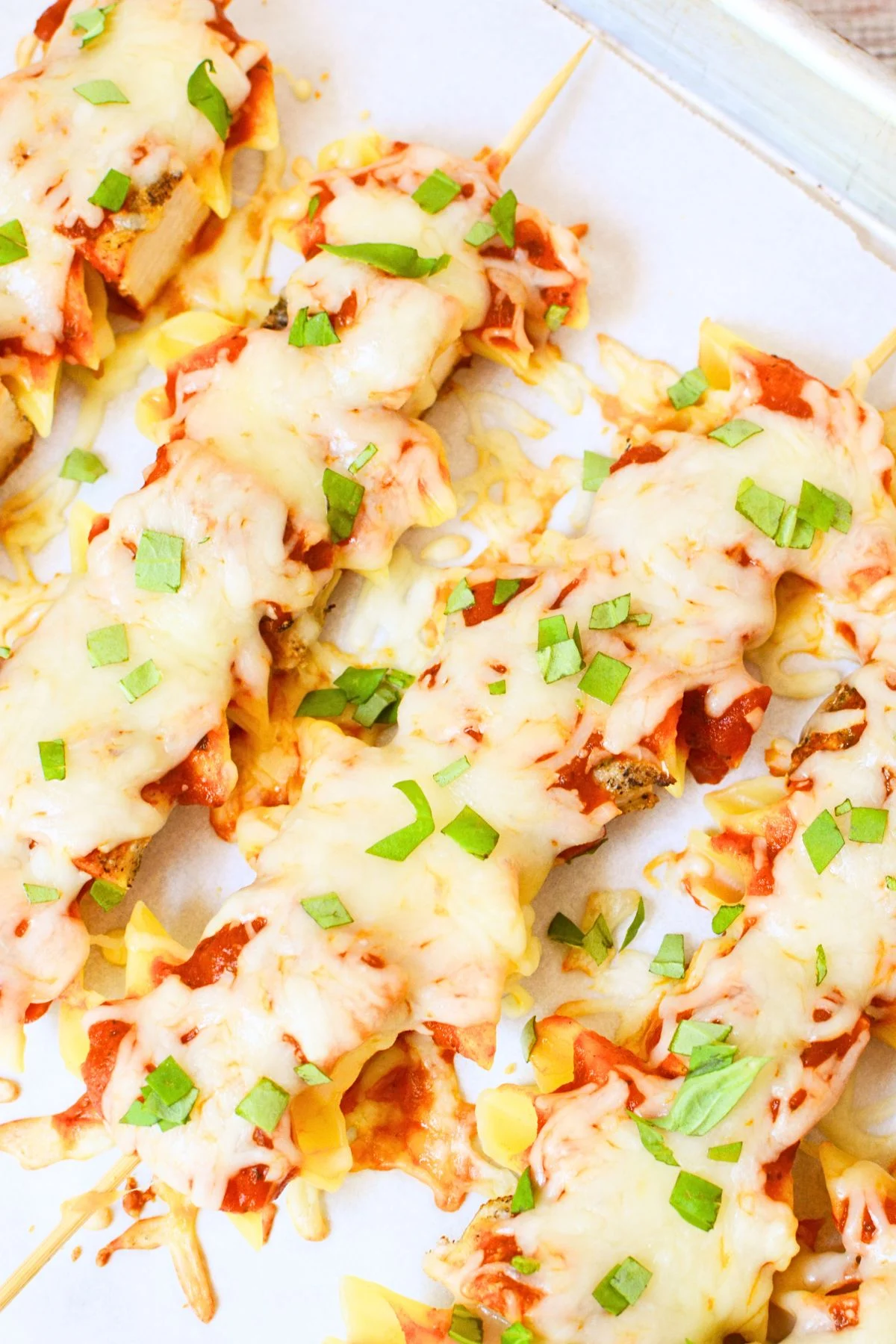 Chicken Parmesan pasta skewer with chicken, penne, marinara, mozzarella, and basil