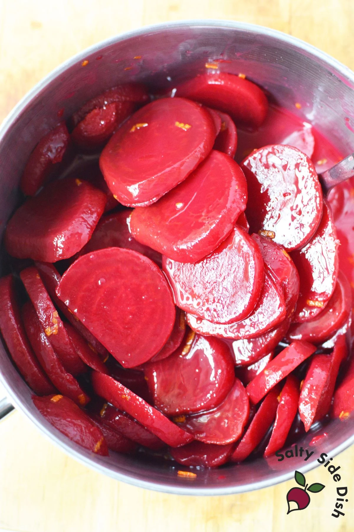 Sliced Harvard beets coated in sweet and tangy sauce in a saucepan