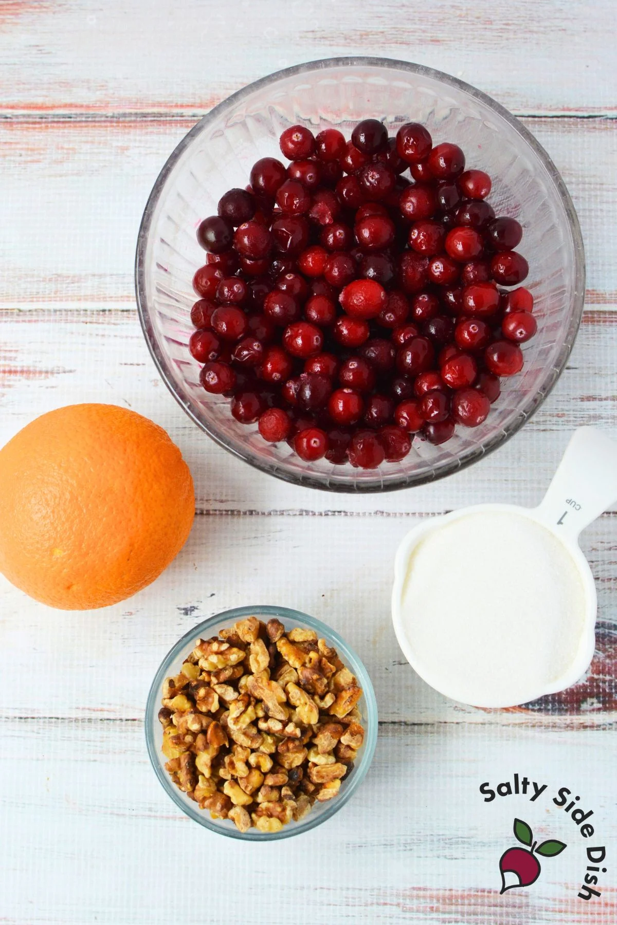 Cranberry orange relish ingredients including cranberries, orange, sugar, and walnuts